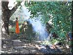 579  Champasak Wat Phu Champasak Monks-fire-smoke.JPG